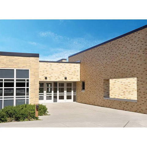 Building exterior with Crosstour 26W Carbon Outdoor Integrated LED Wall Pack With 4000K Neutral White, Bronze Finish on brick wall