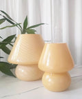 Swirl Mushroom Glass Lamp In Striped Pink, Hand Blown Translucent Murano Style Table Bedside Light on white surface with plants