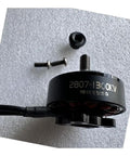 1300KV FPV Brushless Motor For RC Drones With Nut 2807 size, lightweight with mounting screws on textured background