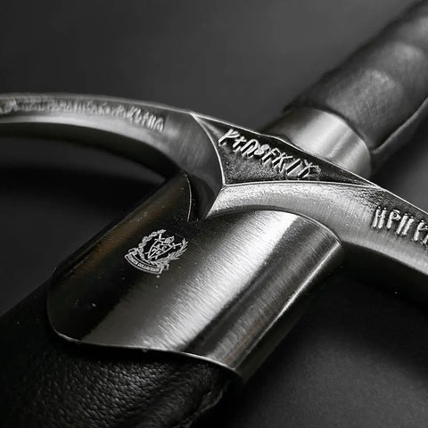 Close-up of 41.25 Inch One Hand Medieval Sword With Dull Carbon Steel Blade, showing engraved hilt and faux leather grip.