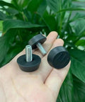 Adjustable Leveling Feet Set For Furniture And Cabinets Black Glide Pads With M6 And M8 Screws Rust Resistant Plastic Bases 4 Pack 8 Pack Multiple Size Options Easy DIY Installation Delivers Stable Leveling On Uneven Floors, black feet in hand