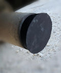 Close-up of Smoke Machine Cap Plugs Kit 9 Piece Set for Leak Tests sealing a round opening on an automotive exhaust pipe.