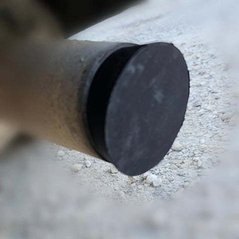 Close-up of Smoke Machine Cap Plugs Kit 9 Piece Set for Leak Tests sealing a round opening on an automotive exhaust pipe.