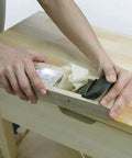 KANNA Japanese Manual Smoothing Block Plane 60mm in use on wood surface, white oak body with oil finish, precise shaving for fine carpentry