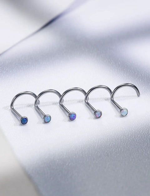 Five Pack 18g ASTM F136 Titanium Nose Studs With Vibrant Opal Tops For Nostril Piercings lined up on a white surface.