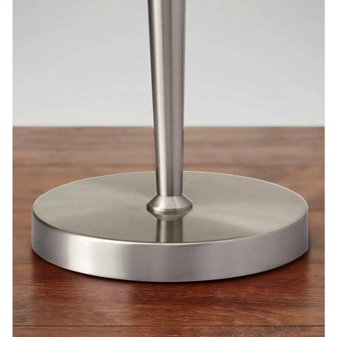 Hayworth Table Lamp With White Linen Drum Shade And Brushed Steel Finish 22 Inch Tall Pull Chain base detail on wood surface