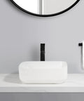 USZWBY Vessel Sinks Household Small Size Square Rounded White Countertop Ceramic Basin Bathroom Kitchen Sink Vegetable Bathroom Bowl Sink on a countertop with a black faucet.