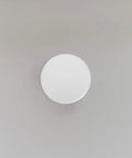 Slick White Iron Fire Sprinkler Covers 2 Pack Discreet Ceiling Plates on gray wall, 3.34" round, stain-resistant finish.