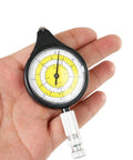 Map Measurer Metal Wheel Outdoor Navigation Tool for Camping Hiking Cycling, measuring gauge in hand, black and yellow dial.