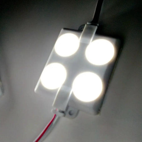 Close-up of a bright 12V 40 LED 2835 van interior light kit with project lens installed, glowing with no shadow.