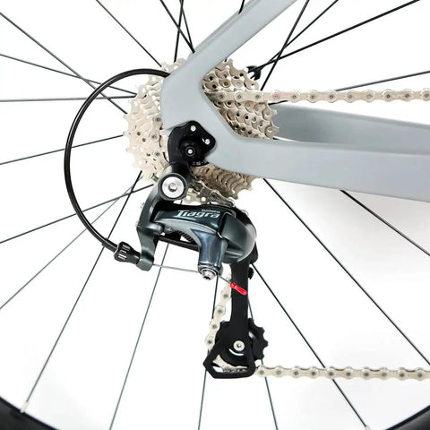 Close-up of Tiagra 20-speed drivetrain on Toray T800 Carbon Frame Road Bike Model H With Tiagra 20 Speed Drivetrain, Ultra Lightweight 18.7 Lb Build, Size 52 Fits 5ft 8in To 5ft 9in, Celeste Finish, Minimal Logo Ready, Limited Lifetime Warranty On Carbon Frame.