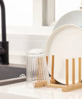 Top Shelf Bamboo Dish Drying Rack Stand Multi Purpose Plate Drainer For Kitchen Counter with plates and glass.