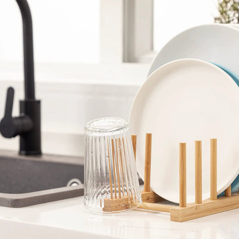 Top Shelf Bamboo Dish Drying Rack Stand Multi Purpose Plate Drainer For Kitchen Counter with plates and glass.