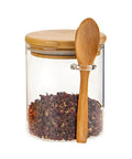 Clear Airtight Glass Coffee Canister And Food Storage Jar With Tough Locking Lid holding spices and wooden spoon, showcasing airtight design.