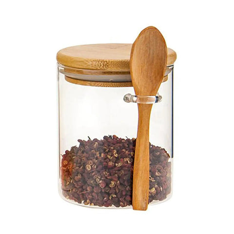 Clear Airtight Glass Coffee Canister And Food Storage Jar With Tough Locking Lid holding spices and wooden spoon, showcasing airtight design.