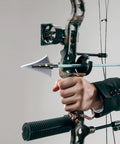 Hand holding a bow with a 125 Grain Fixed Hunting Broadheads With Stainless Steel Blades And Right Bevel For Compound Bow