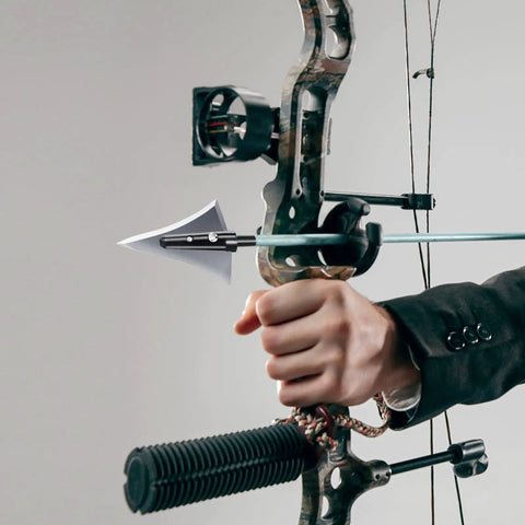 Hand holding a bow with a 125 Grain Fixed Hunting Broadheads With Stainless Steel Blades And Right Bevel For Compound Bow