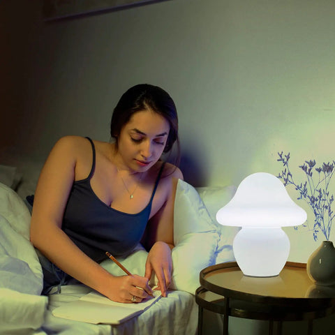 Milk White Glass Mushroom Lamp Small Translucent Nightstand Light for Bedroom and Living Room beside woman writing in bed.