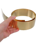 Thin Brass Sheet Roll And Brass Foil For DIY Jewelry Making And Craft Projects With High Thermal Conductivity And Wear Resistance For Mechanical Parts Decorative Projects Garden Crafts And Grounding Uses, hand holding rolled brass foil