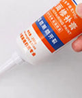 DIY Wall Repair Paste For Holes Quick Drying Crack Fix Kit With Strong Adhesion Drywall Filler tube held in hand