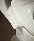 Heated Bidet Toilet Seat With Wireless Remote control panel showing buttons for warm spray and settings in biscuit color.