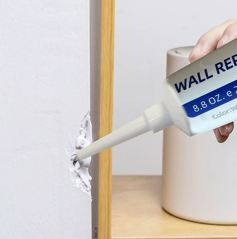 Person using Drywall Patch Repair Kit 250g With Scraper Quick Dry Putty For Holes Cracks And Dents On Concrete And Plaster Waterproof Multi Function Repair Paste For No Mess Easy DIY Home Wall Fix on a wall hole