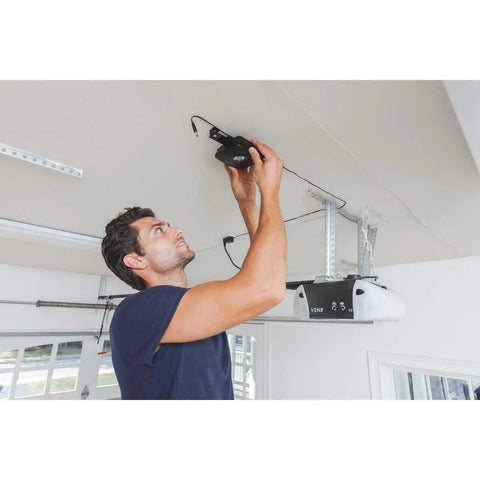 Man installing MyQ-Garage system to control your garage door from your phone anywhere open it on the go monitor it and get real time alerts