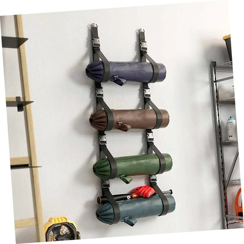 Heavy Duty Adjustable Wall Storage Straps With Badass Rugged Buckles Perfect For Camping Chairs Yoga Mats And Tents holding rolled mats on wall.