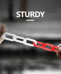 Hands pulling 32 Foot Plastic Chain With 6 Connector Kits For Linking Traffic Cones And Barriers A Pro Grade Setup For Construction Sites Roadwork Parking Lots Driveways And Home Use