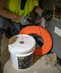 Worker using Poly Pull Line For Wire Pulling, Orange Tracer Cord from a reel for light duty cable string, high visibility orange and white.