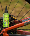 Saver Bundle Wet Bike Chain Lube And Bike Cleaner Set Natural Eco Friendly Palm Oil Free Made In UK next to bicycle wheel.