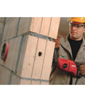 Worker using Pro Grade Handheld Dry Diamond Core Drill System With Case For Sharp, Efficient Core Cutting on concrete wall