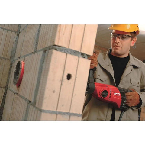 Worker using Pro Grade Handheld Dry Diamond Core Drill System With Case For Sharp, Efficient Core Cutting on concrete wall