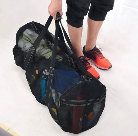 Person carrying XXL Mesh Duffle Bag for scuba snorkel gear and water sports equipment, showcasing ultra roomy design.