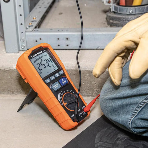 Technician using ET600 Multimeter Megohmmeter Insulation Tester With Auto-Ranging TRMS Readouts for electrical diagnostics