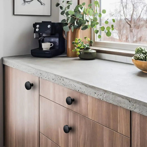 30 Pack Go To Matte Black Cabinet Knobs For Cabinets And Dresser Drawers on wooden kitchen drawers with concrete countertop.