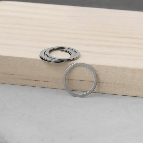 8Pcs Beefed Up Rc Differential Shim Set For Armma 6s BLX Rc Cars Outer Diameter 16Mm Inner Diameter 13Mm Thickness 0.2Mm Steel Diff Spacer Silver Compatible With Kraton Talion Notorious set on a wooden surface.