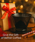 Pour Over Coffee Filter Cone, Number 1 Size, Black, BPA Free Polypropylene, Reusable Portable Brew Buddy For 1 To 2 Servings, Easy Instructions Included next to holiday gift box and candy cane on table