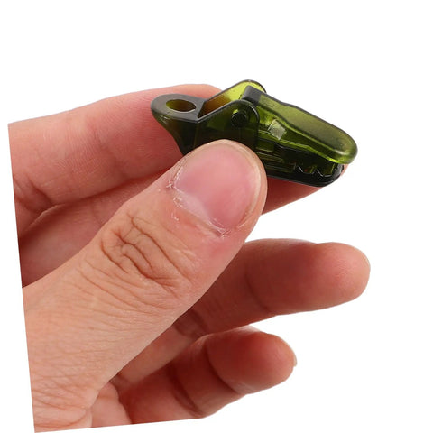 Close-up of Heavy Duty Tarp Clips And Tent Clamps Weatherproof Plastic held in hand for lock tight fastening of outdoor gear