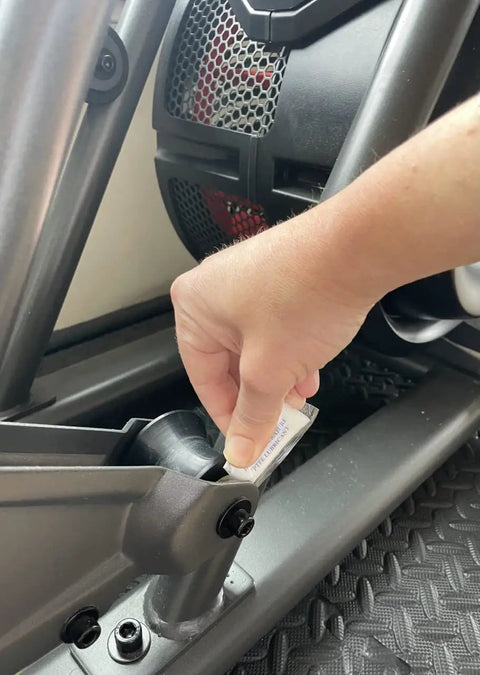 Hand applying PTFE Grease For Fitness Equipment 5 Pack Lubricant For Bearings And Joints to gym machine joint
