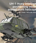 UH Huey RC Helicopter For Grownups Brushless Motor Flybarless Six Axis Gyro Altitude Hold And 3D Inverted Flight Ideal For Indoor And Outdoor Flying Yellow With Four Battery Pack One Forty Eight Scale in profile view.