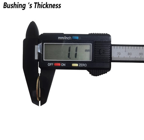 Brass saw blade bushing on a digital caliper, close-up view showing ~1.1 mm thickness