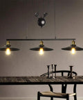 Drop Dead Modern Industrial Chandelier 3 Light Retractable Pulley Pendant, black and brass for farmhouse kitchen table lighting.