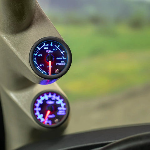 GlowShift oil pressure gauge, 2-1/16 in, black dial with smoked lens and blue backlit display, two gauges shown.