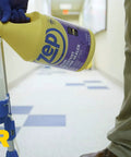 Pouring Heavy Duty Stain Resistant Floor Sealer One Gallon Clear Gloss Coating into application tool in hallway.