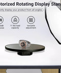 JAYEGT Motorized Rotating Display Stand, 10-Inch Mirror Finish Turntable showing a watch on a sleek black surface for photography.