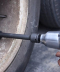 Using Built Tough CrV Steel Three Quarter Inch Drive Impact Extension Bar Set on car wheel for tight space access