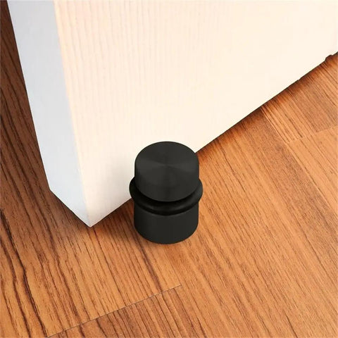 2 Pack Cylindrical Door Stops With Brass Construction And Oil Rubbed Bronze Finish Floor Mounted Noise Absorbing Rubber next to door