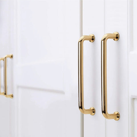 10 Pack Polished Brass Cabinet Pulls Five Inch Center To Center Spacing Five Point Six Inches Overall Length zinc alloy installed on white cabinets