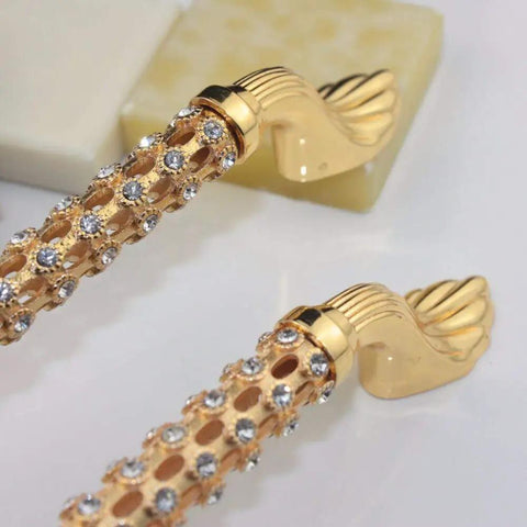 Level Up Your Cabinet Game With These Crisp 96Mm Drawer Pulls Decked Out In Glossy 24K Gold And Heavyweight K9 Crystal That Truly Bring The Hollywood Glamour Everyday - Close-up of golden drawer pulls with crystals.
